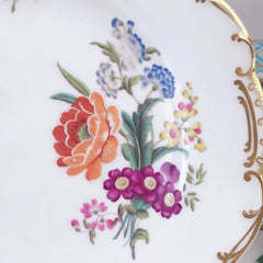 An antique Minton dessert/cabinet plate decorated with handpainted flowers
