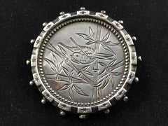 Victorian silver Aesthetic Movement brooch engraved with a bird in bamboo