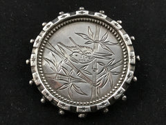 Victorian silver Aesthetic Movement brooch engraved with a bird in bamboo